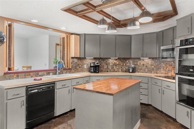 kitchen with gray cabinetry, pendant lighting, a center island, black appliances, and sink