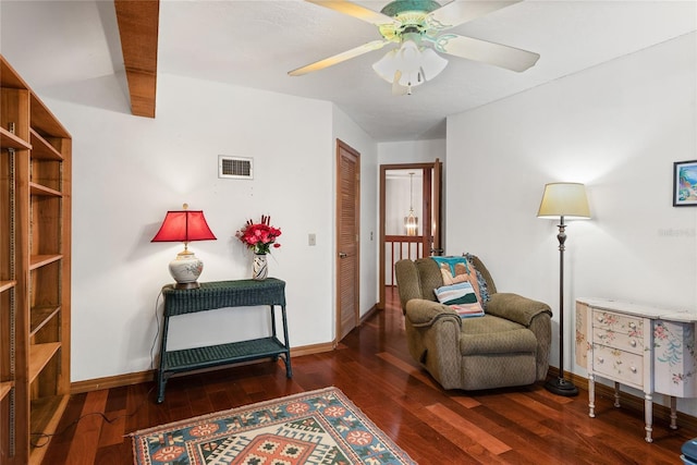 living area with dark hardwood / wood-style floors and ceiling fan