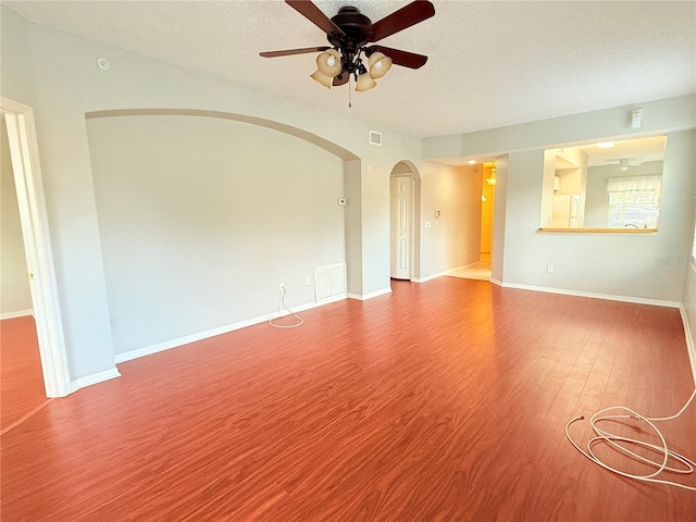 empty room with wood-type flooring, a textured ceiling, and ceiling fan