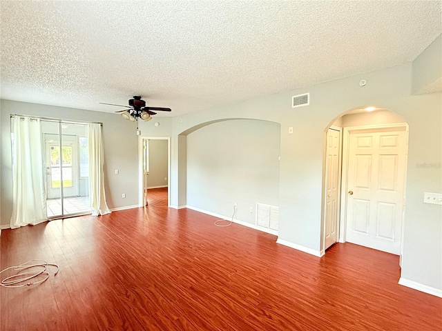 unfurnished room with ceiling fan, wood-type flooring, and a textured ceiling