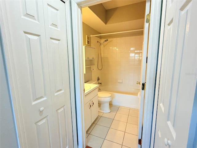 full bathroom featuring tile patterned flooring, vanity, toilet, and tiled shower / bath