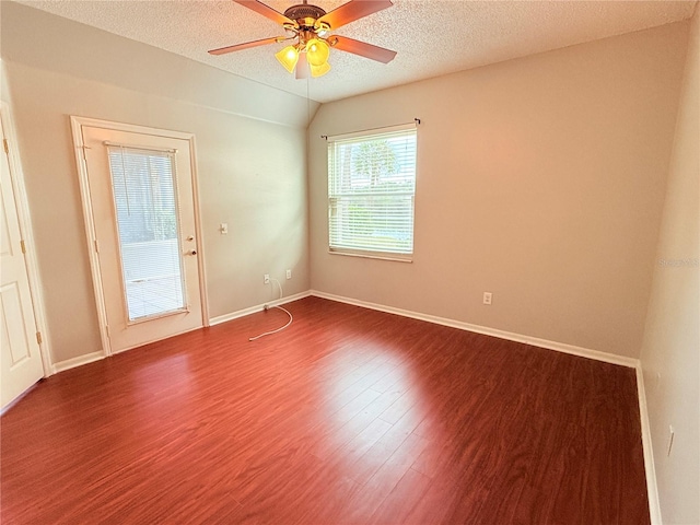 unfurnished room featuring ceiling fan, dark hardwood / wood-style flooring, and a textured ceiling