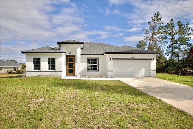 view of front of house with a garage and a front yard