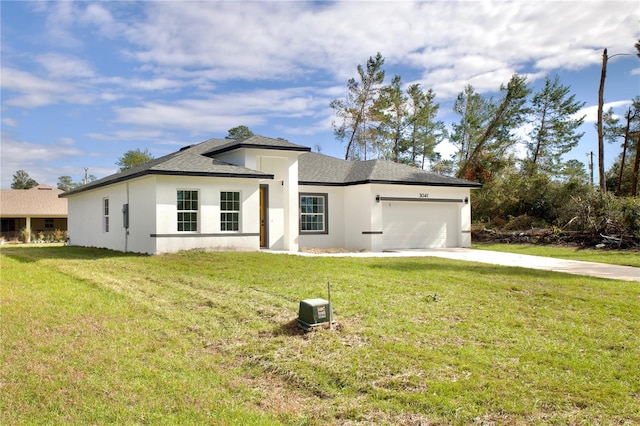 view of front of property featuring a garage and a front lawn