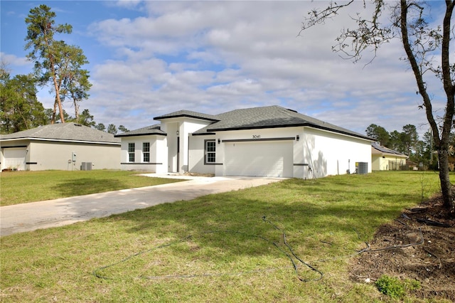 prairie-style home with cooling unit, a front lawn, and a garage