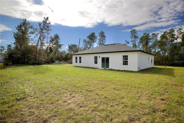 back of property featuring a yard