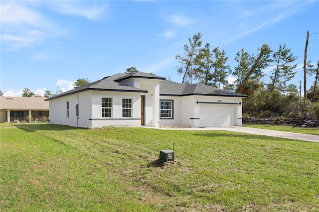 view of front of home with a front yard and a garage