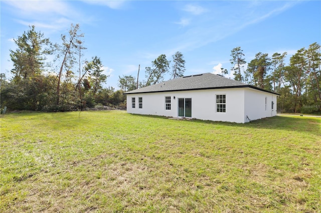 back of property featuring a lawn