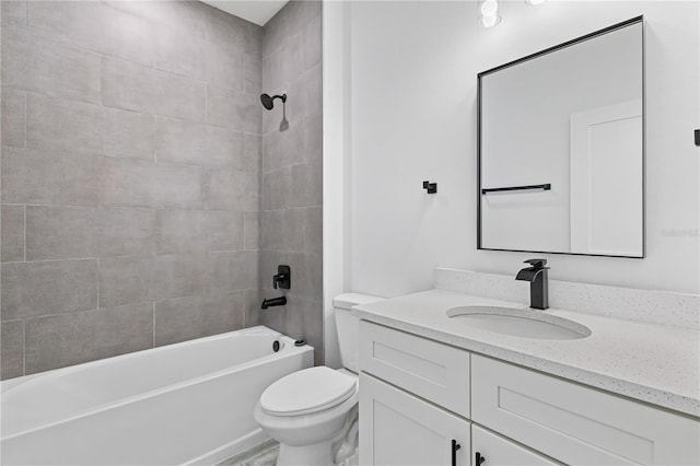 full bathroom with vanity, tiled shower / bath combo, and toilet