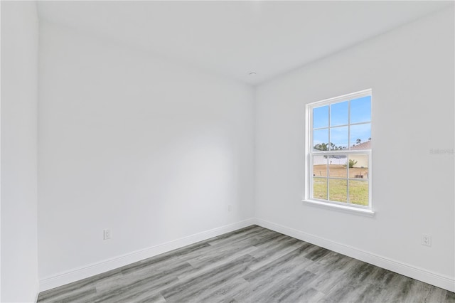 unfurnished room with light wood-type flooring