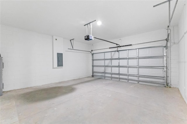 garage featuring electric panel and a garage door opener