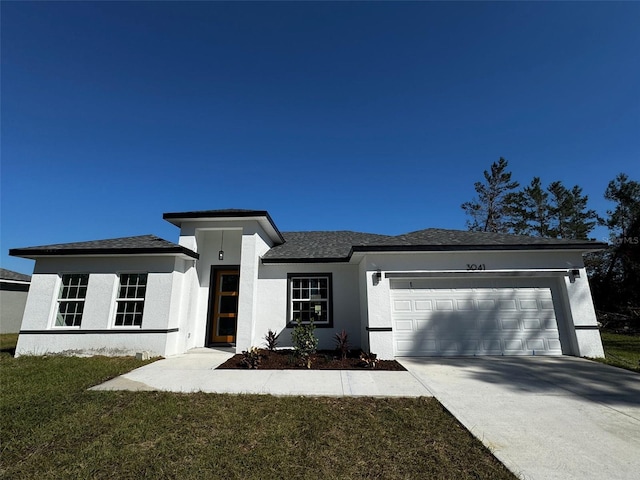 view of front facade featuring a front lawn and a garage