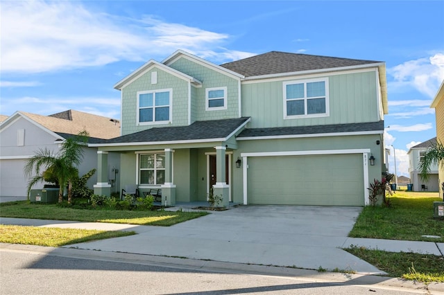 view of front of property featuring a front lawn and a garage