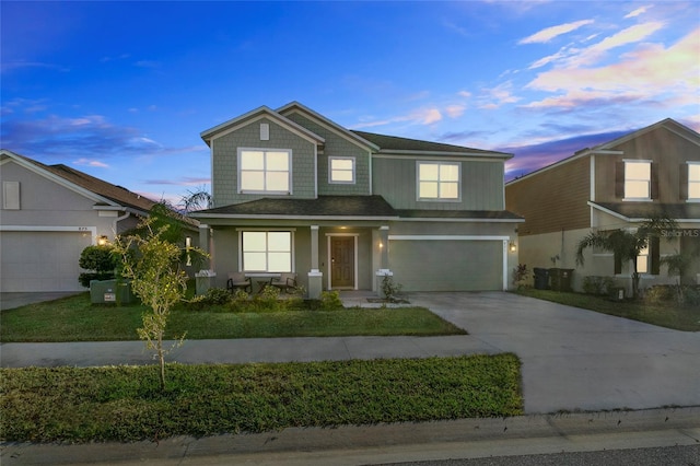 traditional-style home featuring a garage and driveway