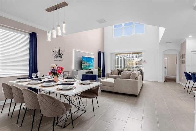 dining area featuring a notable chandelier, ornamental molding, and a wealth of natural light