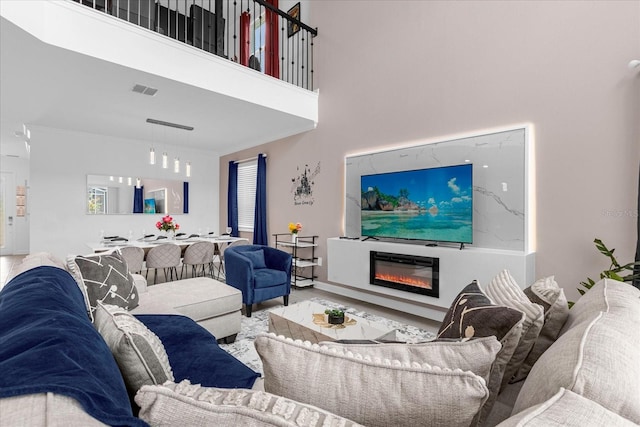 living room featuring a towering ceiling