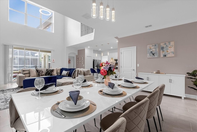 dining room featuring a notable chandelier and a high ceiling