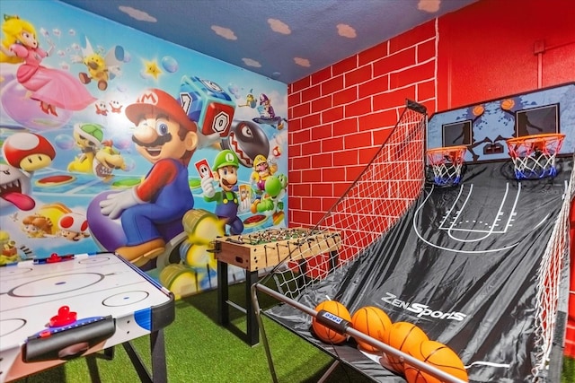 game room with carpet floors and a textured ceiling