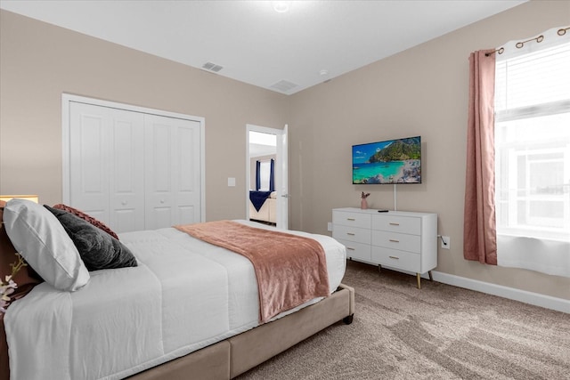 bedroom with light carpet and a closet