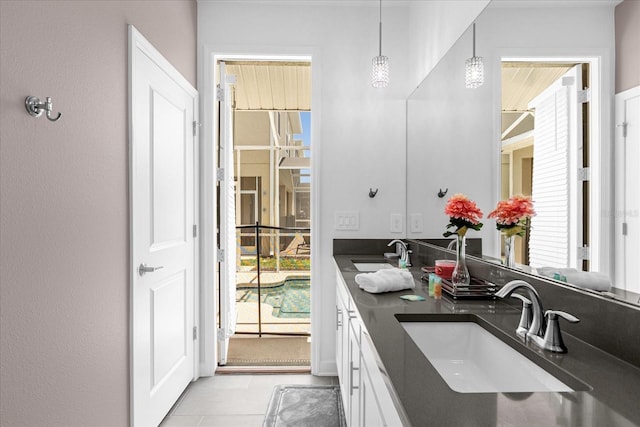 bathroom with plenty of natural light, vanity, and tile patterned flooring