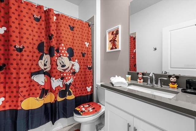 bathroom with tile patterned floors, vanity, toilet, and walk in shower