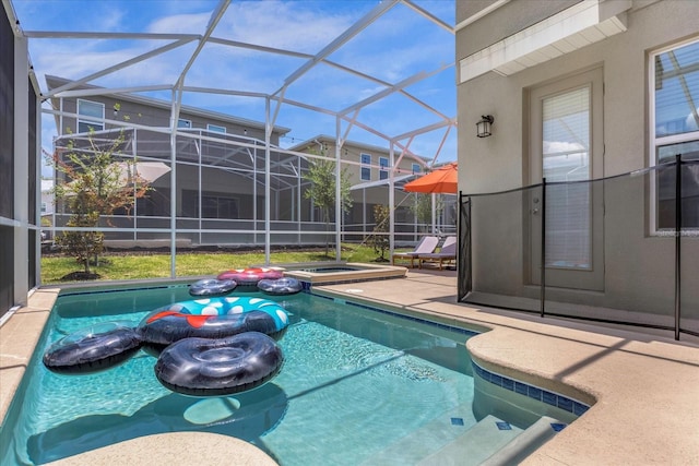 view of swimming pool featuring glass enclosure, an in ground hot tub, and a patio