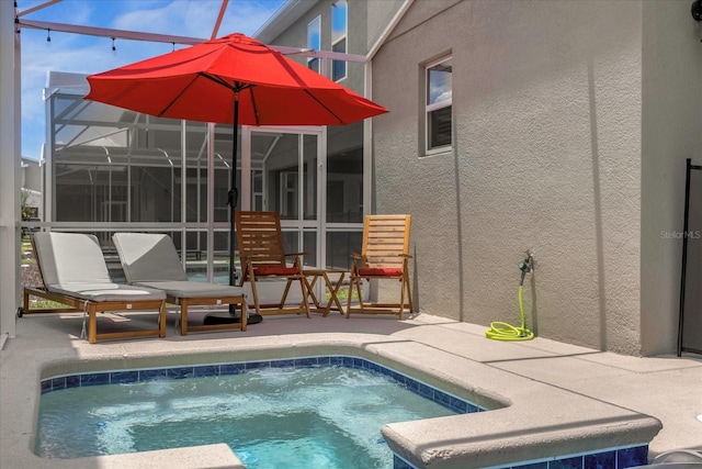 view of swimming pool with a patio area and a lanai