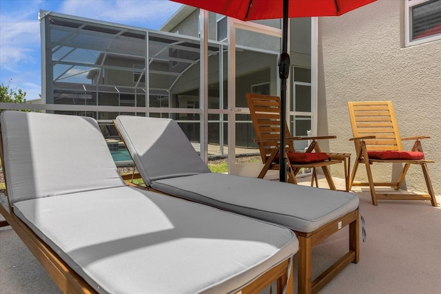 view of patio featuring a lanai