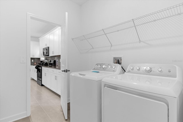 washroom featuring light tile patterned flooring and independent washer and dryer