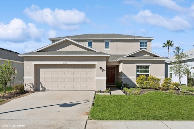 view of front of house with a garage and a front lawn