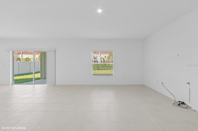 tiled spare room with a wealth of natural light