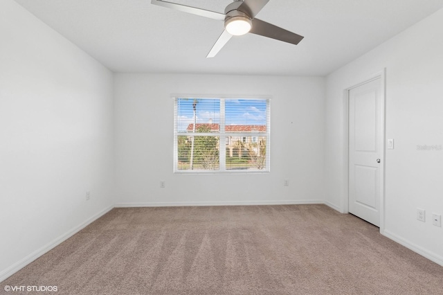 empty room featuring light carpet and ceiling fan