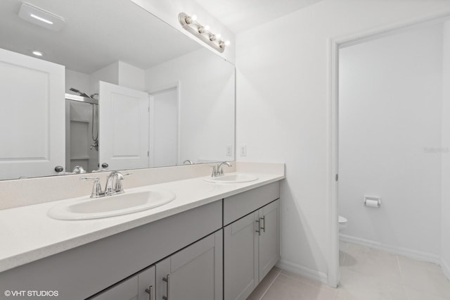 bathroom featuring tile patterned flooring, vanity, and toilet