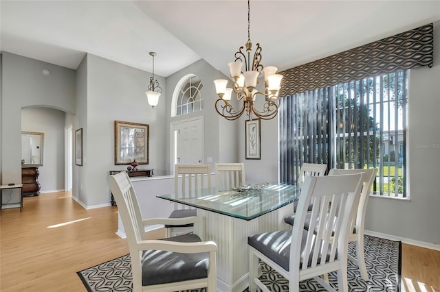 dining room with light hardwood / wood-style floors and a chandelier