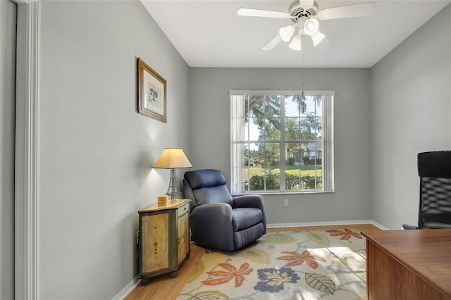 sitting room featuring ceiling fan and light wood-type flooring