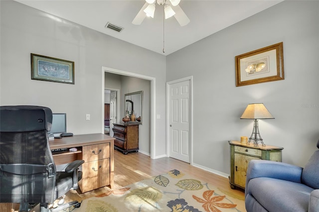 office space featuring ceiling fan and light hardwood / wood-style floors