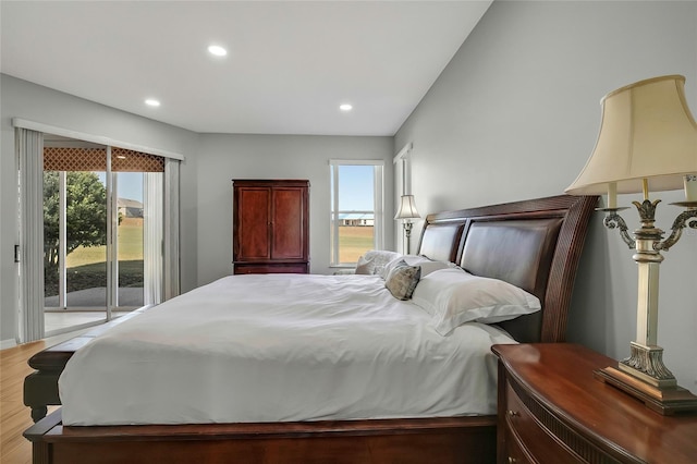 bedroom featuring access to exterior and light hardwood / wood-style flooring