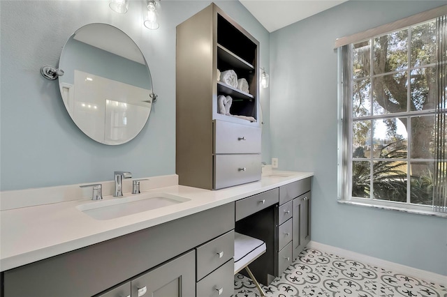 bathroom with tile patterned floors, vanity, and a shower