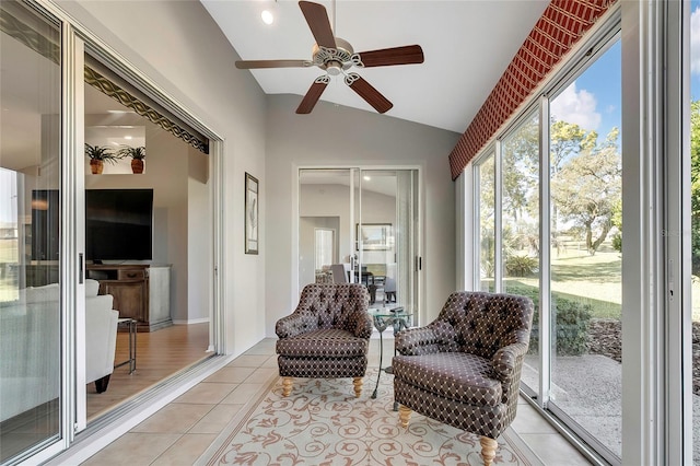 sunroom with ceiling fan and vaulted ceiling