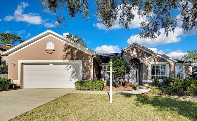 single story home with a garage and a front lawn