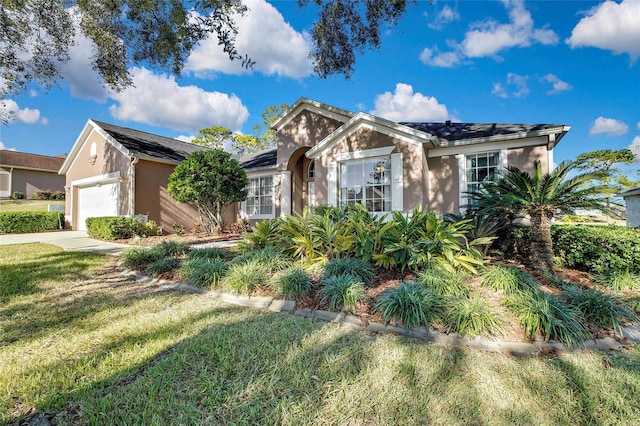 view of front of home with a garage and a front yard