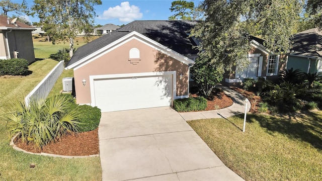 view of front of property with a front yard and a garage