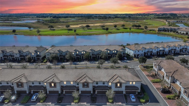 aerial view at dusk with a water view