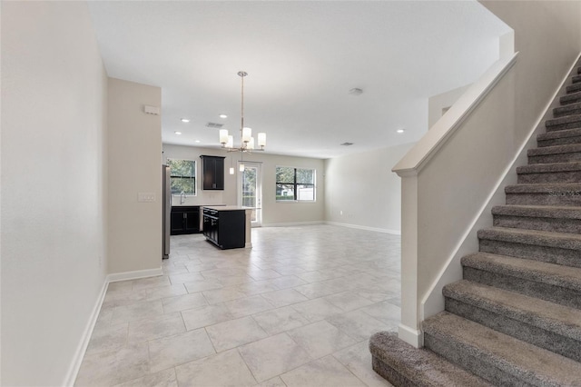 interior space featuring tile patterned flooring, sink, and an inviting chandelier