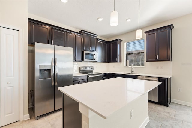 kitchen with a center island, sink, hanging light fixtures, dark brown cabinetry, and stainless steel appliances