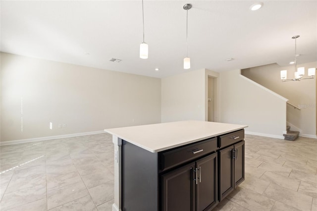 kitchen with a kitchen island, pendant lighting, and an inviting chandelier