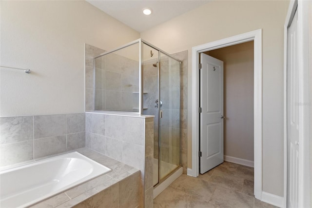 bathroom with tile patterned floors and separate shower and tub