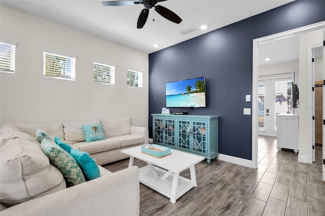 living room featuring hardwood / wood-style flooring, plenty of natural light, and ceiling fan