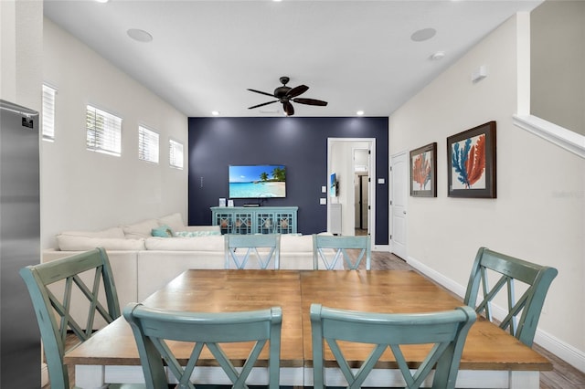 dining room with ceiling fan and hardwood / wood-style floors