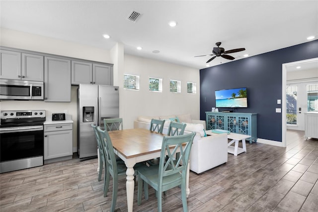 dining space featuring ceiling fan and light hardwood / wood-style floors